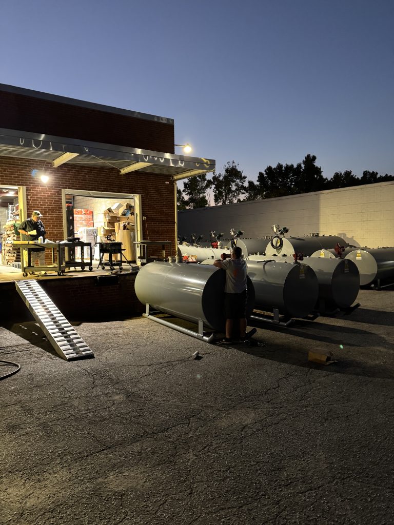 Dan Jones from Prime Fuels, the owner of Phoenix Pump, and employees are setting up fuel tanks and building handpumps for a distribution hub in Swannanoa, NC.
