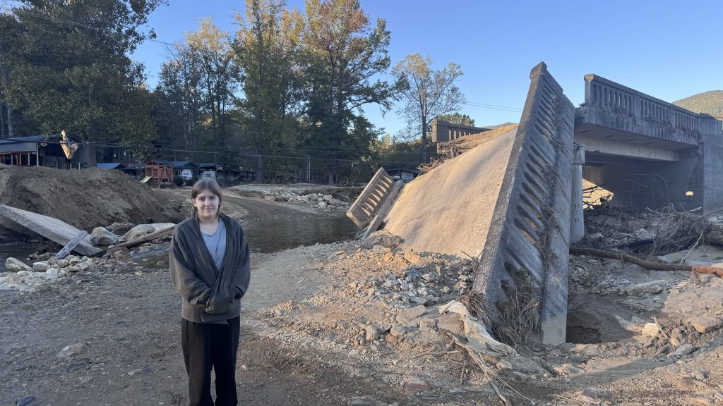 Rhonda's daughter stands next to a collapsed bridge.