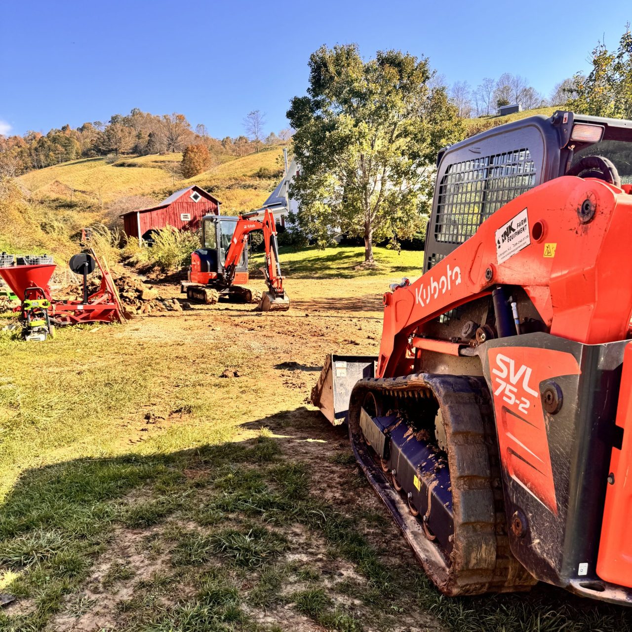 Tractors at work pulling away debris